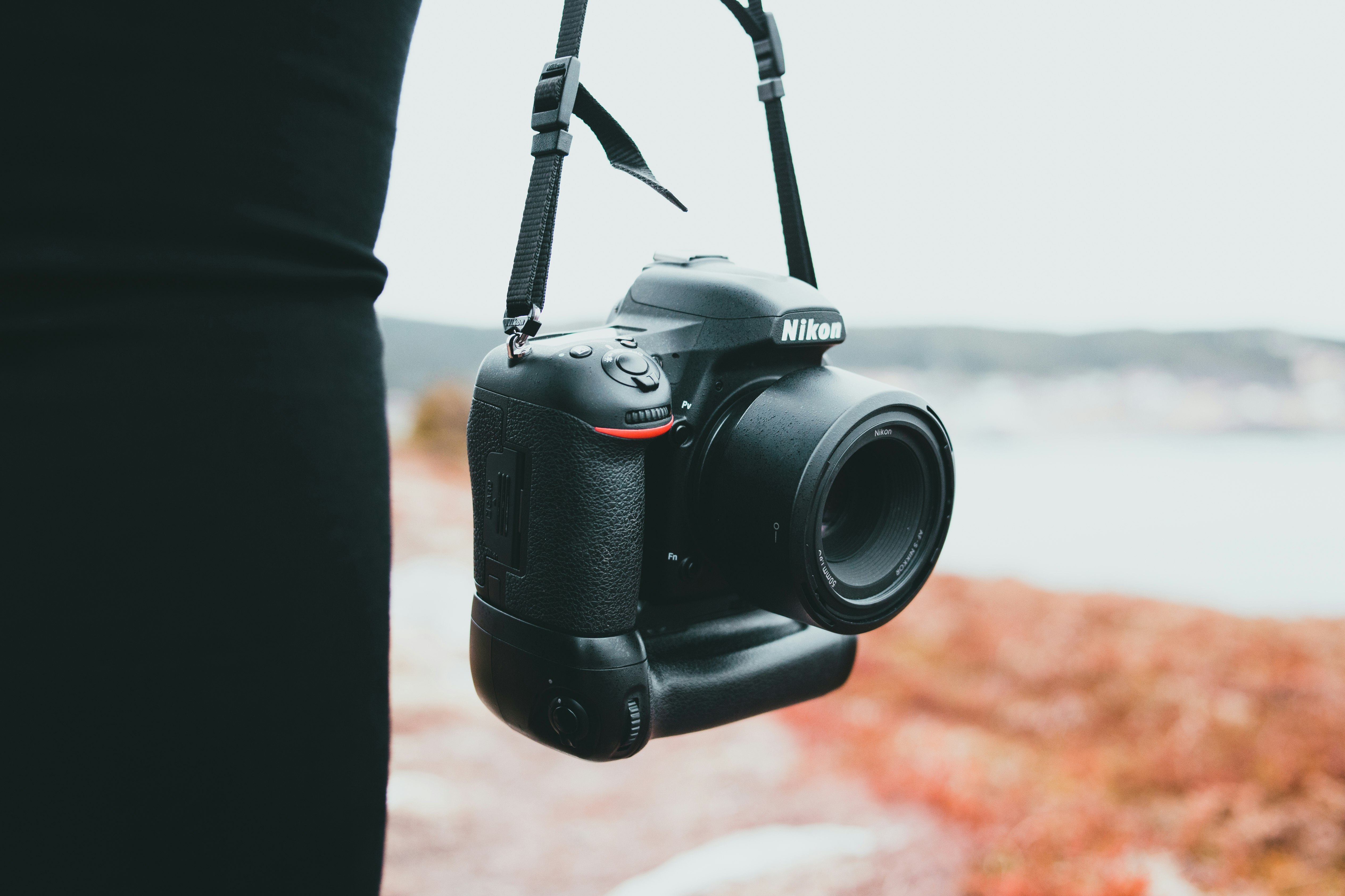 black nikon dslr camera on brown textile